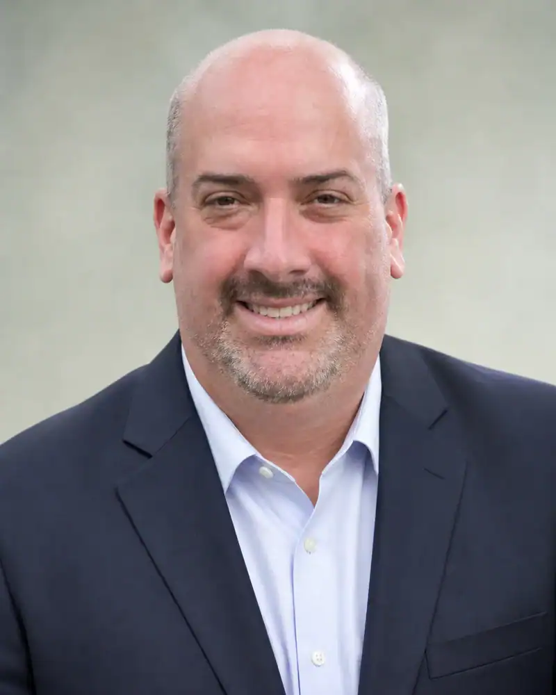 Professional Business Portrait for Townsend Business professional smiling in formal suit for Townsend Strategies.