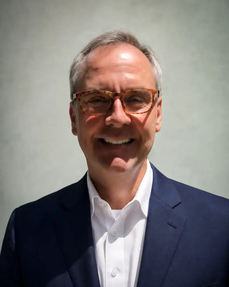 Professional Businessman Portrait for Townsend Smiling businessman in suit and glasses for Townsend Strategies.